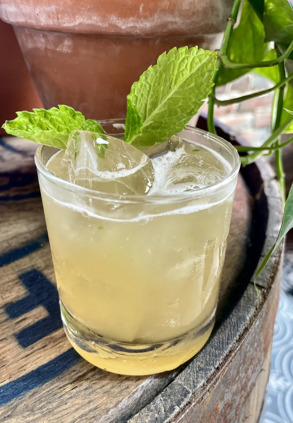 A mint-garnished craft cocktail on a barrel in downtown Nashville